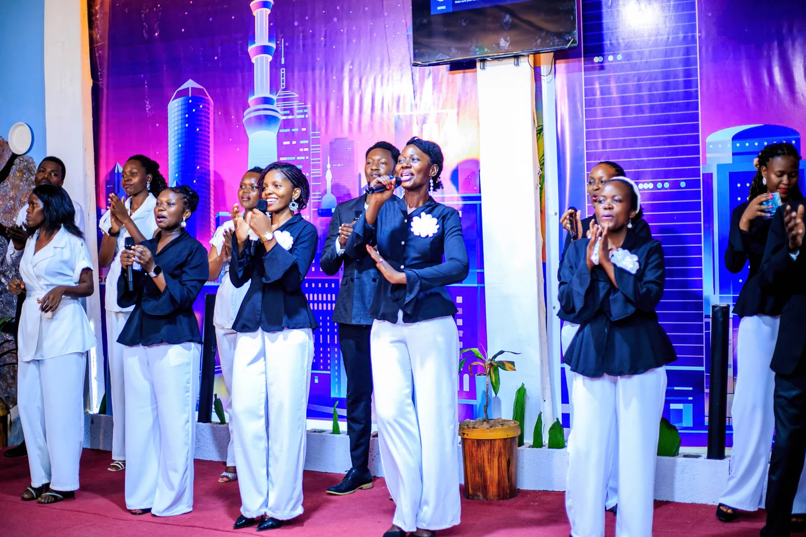 Choir performing on stage at a church worship night, event photography